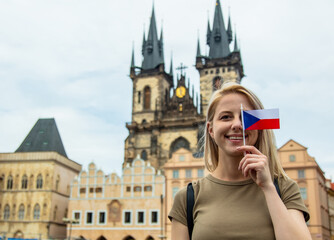 Blonde woman with a flag at central square in Prague, Czech Republic