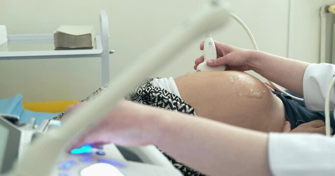 Doctor Doing Ultrasound Scan to a Pregnant Woman. Health Diagnostic in the hospital