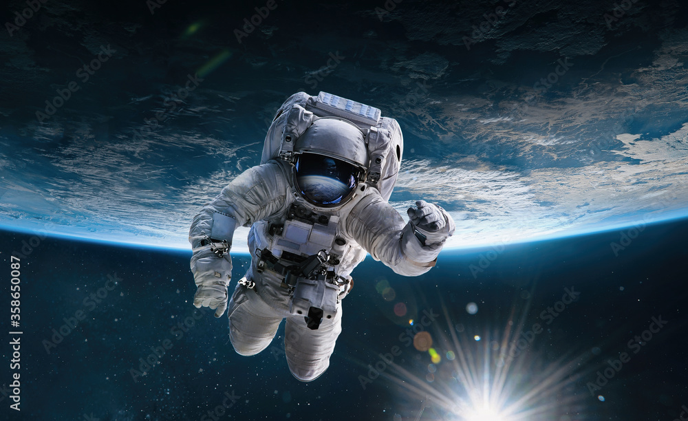 Poster Astronaut in the outer space with Sun over the planet Earth. Abstract wallpaper. Spaceman. Elements of this image furnished by NASA