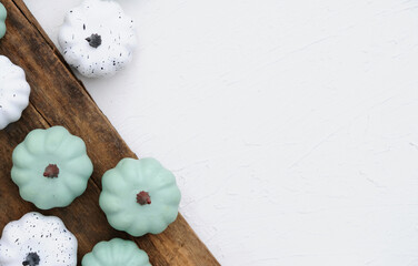 Top view of modern pumpkin decoration for fall Thanksgiving holiday with copy space on white background.