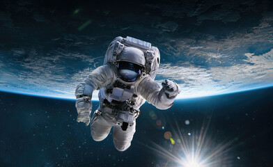 Astronaut in the outer space with Sun over the planet Earth. Abstract wallpaper. Spaceman. Elements...