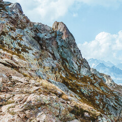 Picturesque mountain scenery with cumulus clouds. Wildlife. Hiking. Daytime.