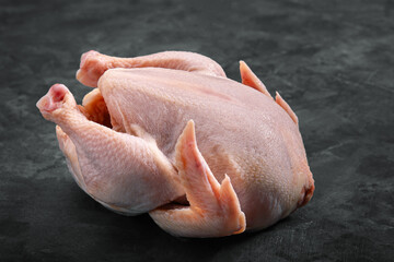 Fresh chicken carcass on a gray background, fresh meat, copy space, photo for grocery stores. dark background