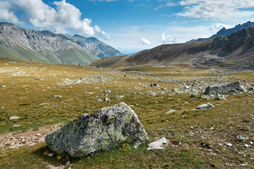Fototapeta na wymiar Picturesque mountain scenery with cumulus clouds. Wildlife. Hiking. Daytime. rocky terrain