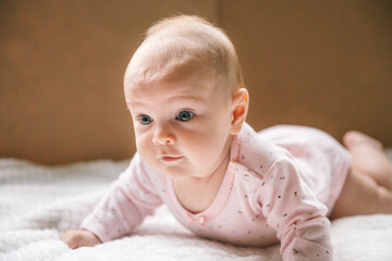 The baby learns to hold its head and lies on its stomach. The benefits of lying on your stomach for motor development