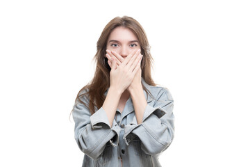 Portrait of a scared teenage girl looking surprised, shocked with a hand covering her mouth, someone gagging her, isolated white background. Human emotions, facial expressions, feelings, body language