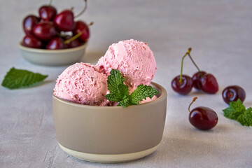 Cherry ice cream in bowl  with fresh cherry . Closeup