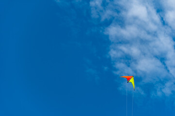 Yellow Kite in Lower Corner, Blue Sky Wispy Clouds