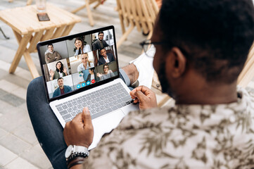 Video call. Video conference. Successful African American freelancer communicate by a video...