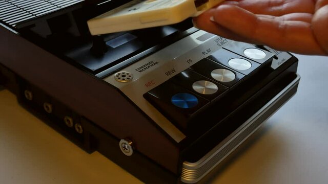 Girl Insert a Compact Cassette, Pressing Play, and then Stop Control Buttons then Eject the Tape on a Vintage Stereo Portable Audio Cassette Tape Player Recorder. 4k Close-Up