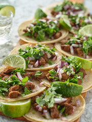 wooden tray with carne asada tacos on corn tortilla