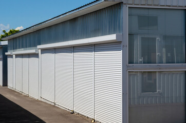 Self-service warehouses with white shutter doors closed.