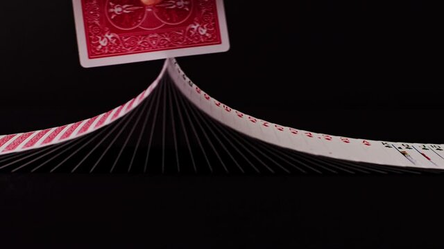 Ribbon of playing cards get turned around with another card