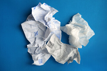 Crumpled paper is a kind of garbage on a blue plain background. Concept of waste recycling.