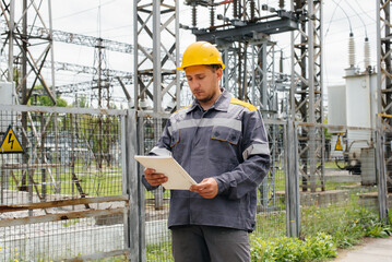 The energy engineer inspects the equipment of the substation. Power engineering. Industry