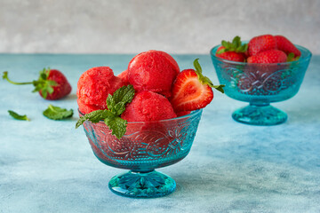 Strawberry ice cream , sorbet in bowl with mint leaves