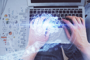 Multi exposure of man's hands typing over computer keyboard and data theme hologram drawing. Top view. Technology concept.
