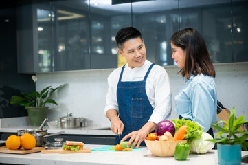 People are showing vegetables and fruits in the kitchen for healthy cooking.