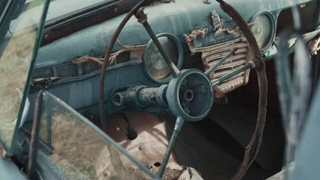 Close-up wheel and panel of old vintage rusty abandoned car