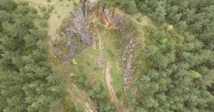 Aerial footage showing a stony canyon in the woods.