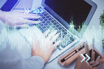 Multi exposure of woman hands typing on computer and forex chart hologram drawing. Stock market...