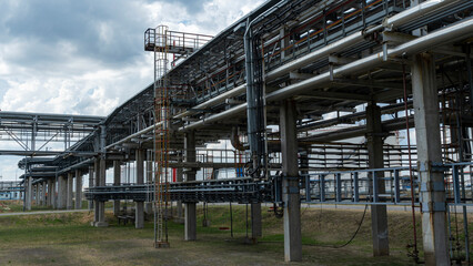 The equipment of oil refining. Close-up of industrial pipelines of an oil-refinery plant. Detail of oil pipeline with valves in large oil refinery.