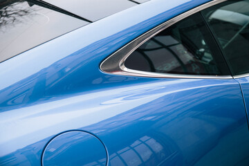Closeup detail of blue sport car . Window.