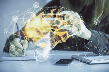 Double exposure of woman on-line shopping holding a credit card and brain hologram drawing. Data...