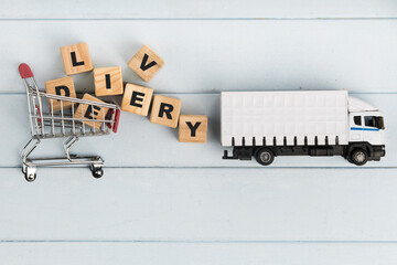 Toy delivery truck with boxes and wooden cubes on blue background