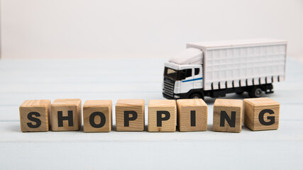 Toy delivery truck with boxes and wooden cubes on blue background