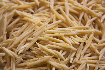 Closeup of a plate of uncooked italian pasta called trofie