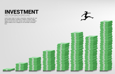 Fototapeta premium Silhouette of businesswoman jump to higher column of money graph. Concept of risk , success and growth in business