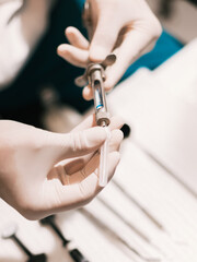 Doctor With Syringe Is Preparing For Injection