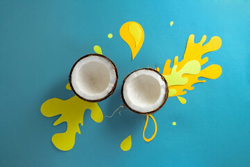 couples of frersh coconut with paper splash on blue background