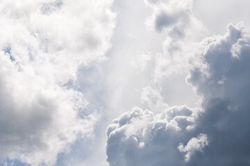 Gray and white fluffy clouds in the pale sky. Beautiful sky