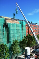 building under construction with crane