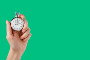 stopwatch hold in hand, button pressed, green background