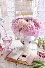 bouquet of pink peonies in porcelain jug on the table