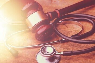 Judge wooden gavel and medical stethoscope