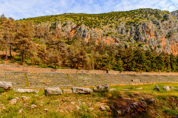 Fototapeta na wymiar It's Amphitheater in Delphi, an archaeological site in Greece, at the Mount Parnassus. Delphi is famous by the oracle at the sanctuary dedicated to Apollo. UNESCO World heritage