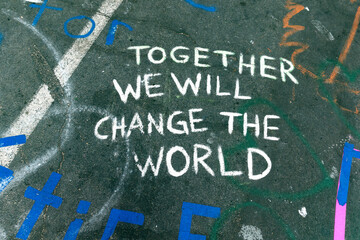 Admonition "together we will change the world" statement on pavement at 38th and Chicago where died. Minneapolis Minnesota MN USA