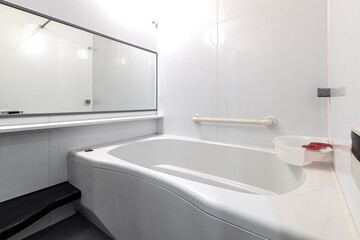 Bathtub in a small modern white bathroom at the apartment