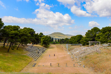 Fototapeta na wymiar It's Ruins of Stadium in Epidaurus, Peloponnese, Greece. UNESCO World Heritage