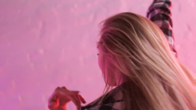 Young beautiful sexy girl dancing strip plastic on high hills on the floor. Action. Slim pole dancer model practicing in studio and dancing on the floor.
