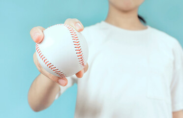 Woman holding a baseball ball. 野球のボールを持つ女性