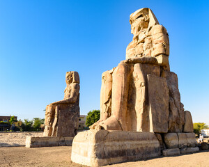 It's Closeup of the Colossus of Memnon, massive stone statue of Pharaoh Amenhotep III, Luxor, Egypt