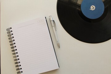 Old Vinyl, notebook and pen in white background