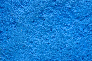 Fototapeta na wymiar Rough blue cement wall surface. This image is suitable for use as wallpaper or background. Sandy surface.