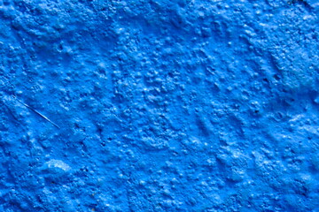 Fototapeta na wymiar Rough blue cement wall surface. This image is suitable for use as wallpaper or background. Sandy surface.