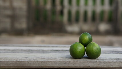 green limes on a wooden table